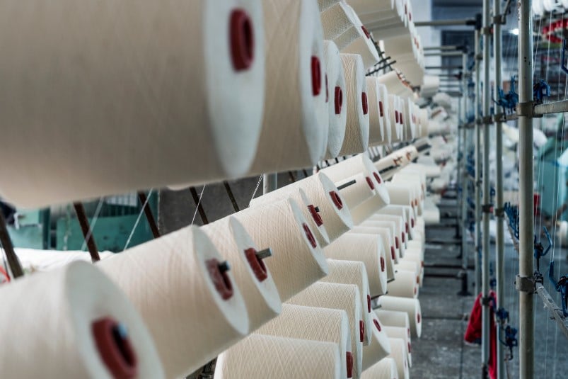 Several spools of narrow white fabric.