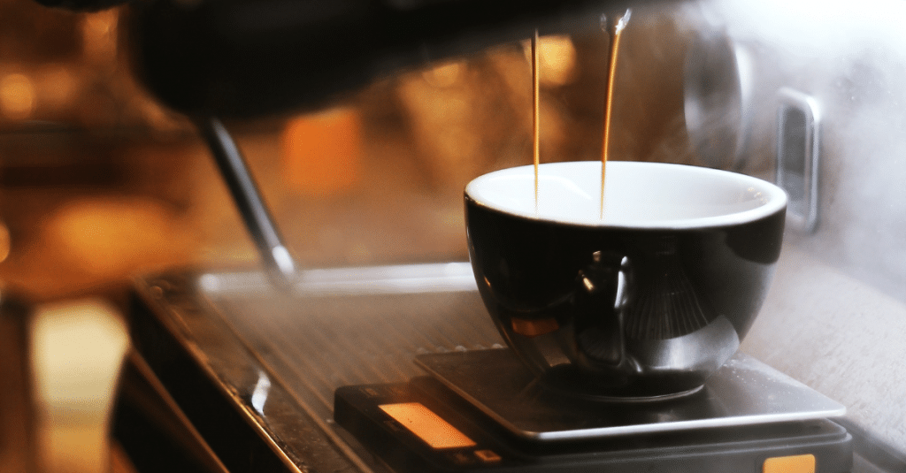 Stylistic close-up of a coffee mug with espresso dripping in.